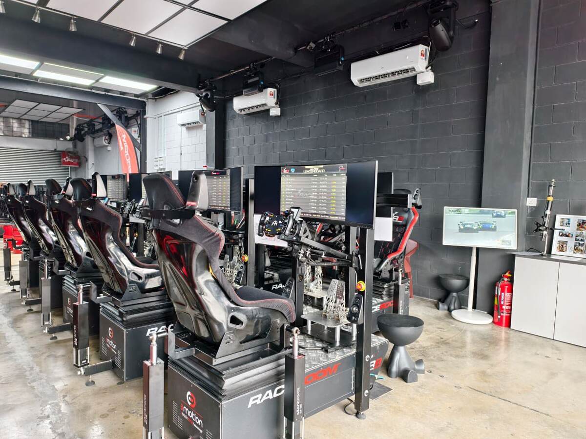 Row of RaceRoom motion simulators at a live event